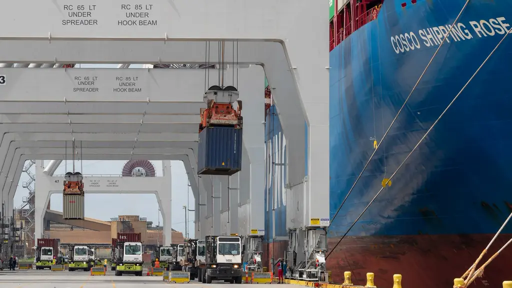 Container being lifted onto a ship at the quay