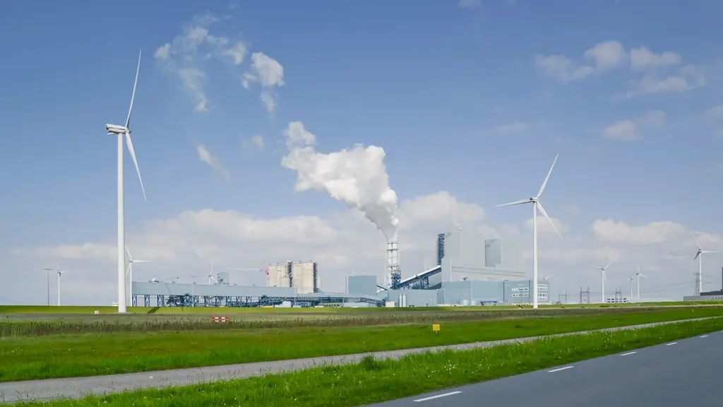 Wind turbines beside an industrial plant