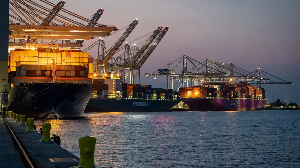 Container ships docked at a port at dusk