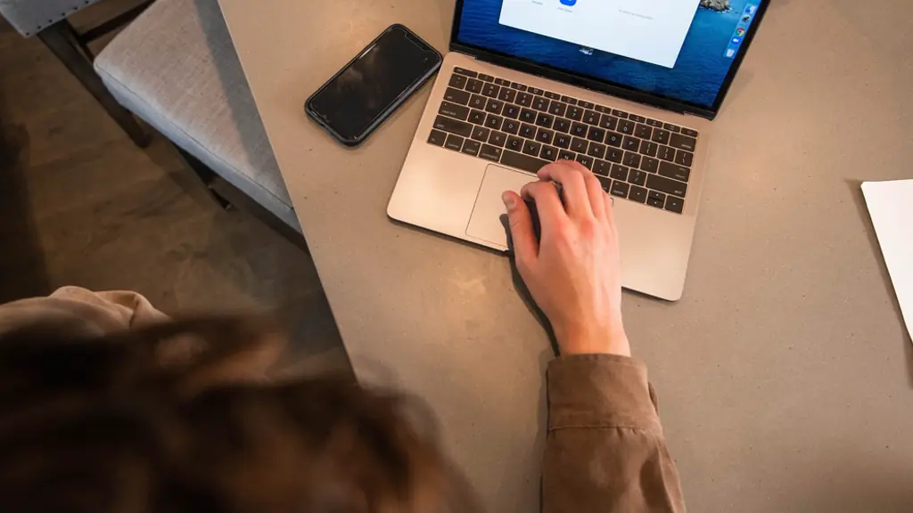 Hand using a laptop, seen from above