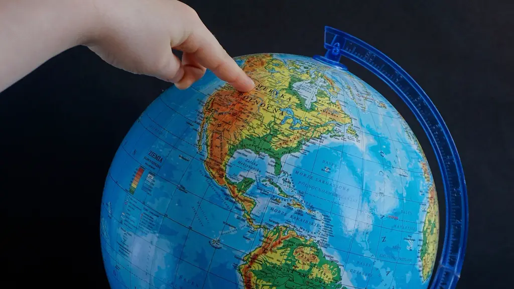 Finger pointing at a globe
